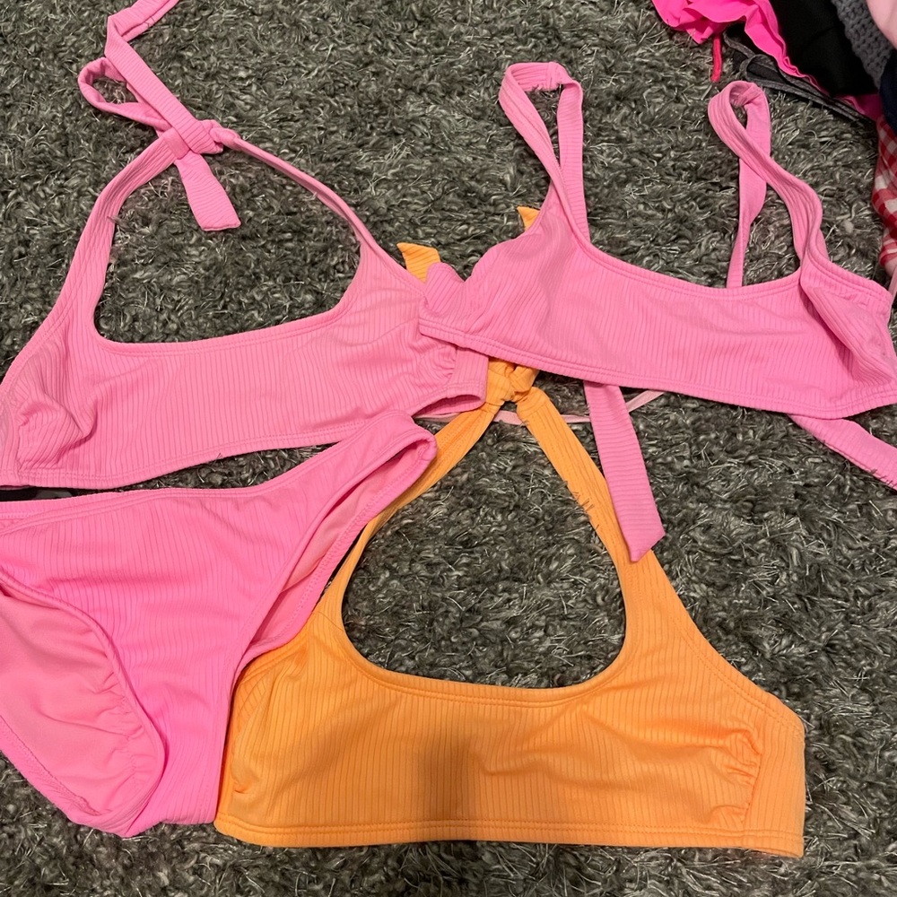 3 swimsuit tops and 1 bottoms